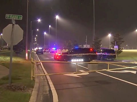 This image made from video provided by WFTV-TV shows police vehicles in Apopka, Florida. Police say an 11-year-old boy retrieved a gun from an unlocked box in his mother's vehicle and shot two 13-year-olds following an altercation that began during a Pop Warner football practice in central Florida.