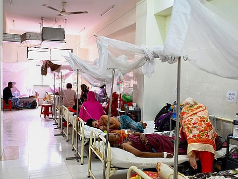 Men receive treatment as they suffer from dengue fever, at the Shaheed Suhrawardy Medical College Hospital in Dhaka.