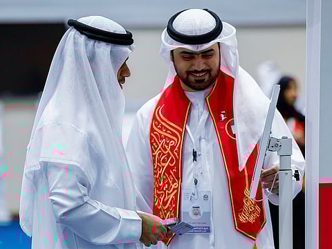 A voter (left) is guided to an electronic ID check before casting his ballot at a polling centre in Sharjah on Saturday, the last day of the FNC elections