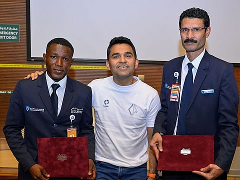 Dr. Shamsheer Vayalil, Founder and Chairman of Burjeel Holdings (centre) with Faizal Khan, right and another security officer.