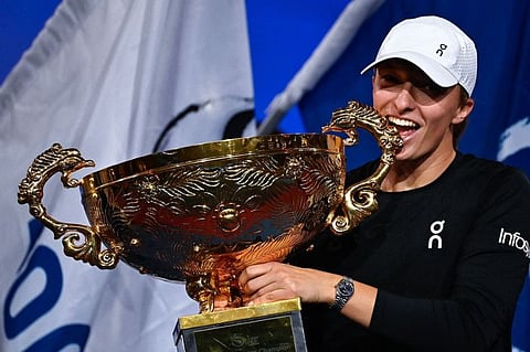 Poland's Iga Swiatek with the trophy after defeating Russia's Liudmila Samsonova in the women's singles final of the China Open in Beijing on Sunday.