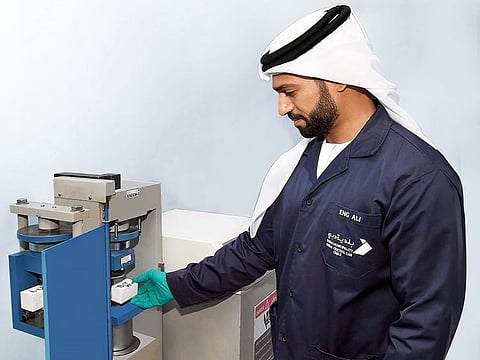 A municipality engineer tests a 3D-printed construction material at Dubai Central Laboratory