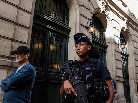 A French police officer carrying a G36 assault rifle patrols outside the Tournelles Synagogue, after increased security measures were put in place at Jewish temples and schools, in central Paris, on October 8, 2023.