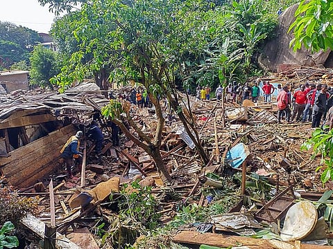 Rescuers search for bodies and survivors after a dam collapsed causing flooding, destroying homes and killing dozens in Mbankolo, Yaounde, Cameroon.
