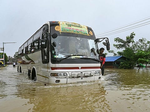 A bus drives through a flooded street in Hpa Yar Gyi township in Myanmar's Bago region