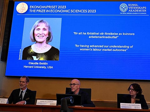 The winner of the 2023 Prize in Economic Sciences in Memory of Alfred Nobel American economist Claudia Goldin is seen on a display as (L-R) the chair of the Committee for the Prize in Economic Sciences in Memory of Alfred Nobel, Jakob Svensson, the Secretary General of the Royal Swedish Academy of Sciences Hans Ellegren and committee member Randi Hjalmarsson address a press conference at the Royal Swedish Academy of Sciences in Stockholm, Sweden, on October 9, 2023.