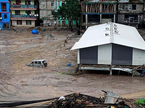 A vehicle is seen partially submerged in water after flash floods triggered by a sudden heavy rainfall swamped the Rangpo town in Sikkim, India -- Oct 5, 2023. The flooding took place along the Teesta River in the Lachen Valley of the north-eastern state, and was worsened when parts of a major dam were washed away