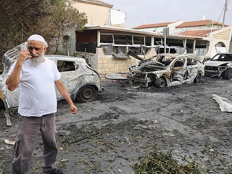 A man inspects the damage in the southern Israeli city of Ashkelon after a rocket attack from Gaza on October 9, 2023.