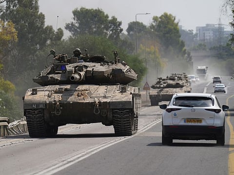 A tank rolls toward the border with Gaza near the town of Netivot in southern Israel on Sunday.