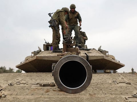 Israeli army soldiers are positioned with their Merkava tanks near the border with the Gaza Strip in southern Israel.