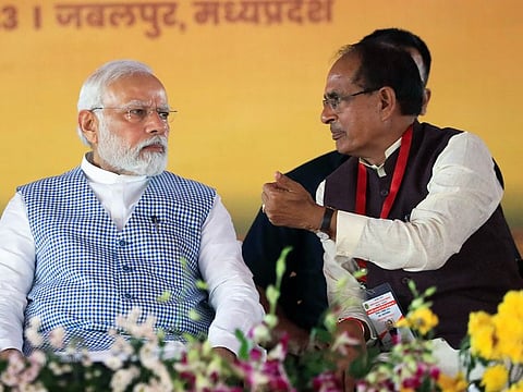 India's Prime Minister Narendra Modi in conversation with Madhya Pradesh Chief Minister Shivraj Singh Chauhan during the inauguration of various developmental projects, in Jabalpur, Madhya Pradesh