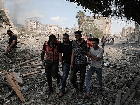 A young Palestinian man cries after finding his father dead in his bombed house in Gaza City.