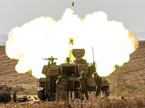 An Israeli army self-propelled howitzer fires rounds near the border with Gaza in southern Israel on October 11, 2023.