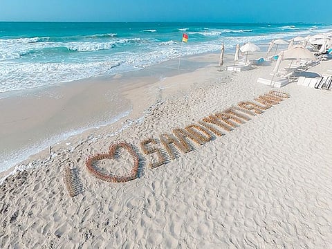 At Saadiyat Beach Club, a sand artist placed the bottles into a large installation