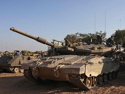 Israeli tanks are positioned near the border with Gaza on October 12, 2023. Israel appeared to be readying for a possible ground invasion of Gaza, but faces the threat of a multi-front war after also coming under rocket attack from militant groups in neighbouring Lebanon and Syria.