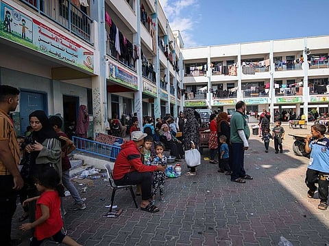 Displaced Palestinians shelter in the courtyard of a school operated by the United Nations Relief and Works Agency (UNRWA) following Israeli airstrikes.
