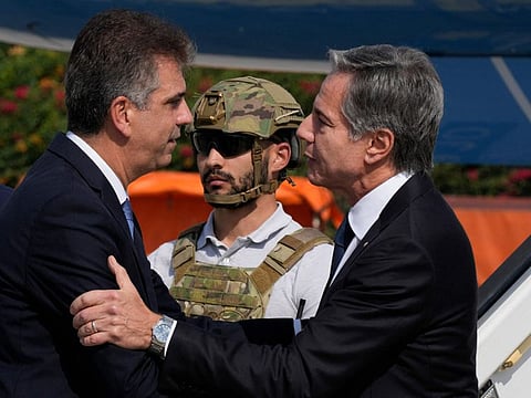 Israel's Foreign Minister Eli Cohen (left) welcomes US Secretary of State Antony Blinken upon arrival at Israel's Ben Gurion Airport on October 12, 2023.