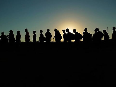 Migrants who crossed the Rio Grande and entered the U.S. from Mexico are lined up for processing by U.S. Customs and Border Protection, Sept. 23, 2023, in Eagle Pass, Texas.