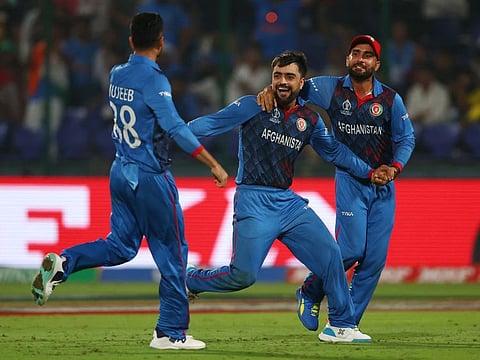 Afghanistan's Rashid Khan celebrates after taking the wicket of England's Adil Rashid at the Arun Jaitley Stadium, New Delhi, on Sunday.