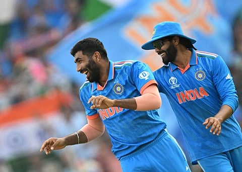India's Jasprit Bumrah celebrates with teammate Ravindra Jadeja after taking the wicket of Pakistan's Mohammad Rizwan at the Narendra Modi Stadium in Ahmedabad on Saturday.