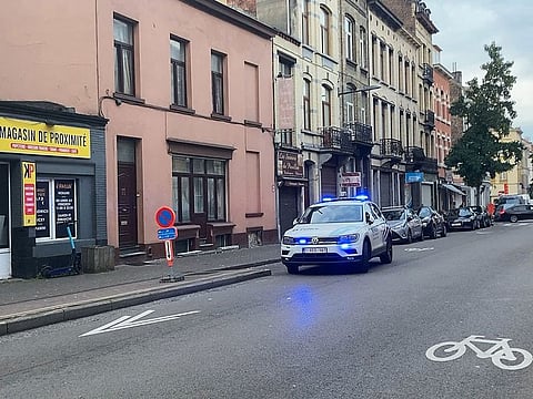 A police car drives near the Eugene Verboekhovenplein in the Schaerbeek area of Brussels, where the suspected perpetrator of the attack in Brussels was probably shot during a police intervention in a cafe.