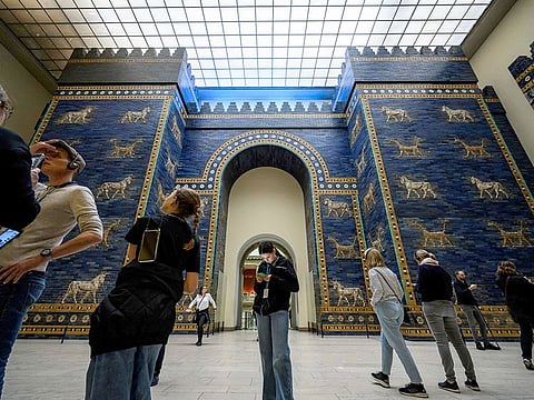 Visitors crowd the Ishtar Gate, constructed circa 575 BC by order of King Nebuchadnezzar II, in the south wing of The Pergamon Museum in Berlin, Germany.
