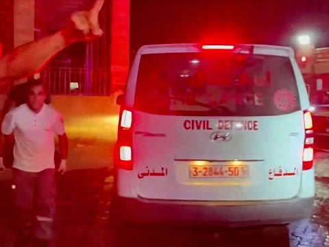 Rescue personnel work at the scene at Al-Ahli Hospital, after hundreds of Palestinians were killed in a strike at Al-Ahli hospital in Gaza.