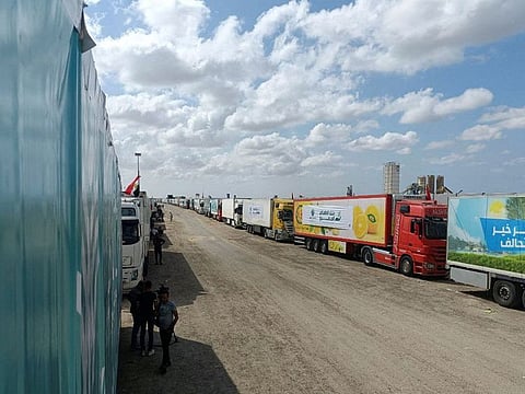 Trucks carrying humanitarian aid from Egyptian NGOs for Palestinians wait for the reopening of the Rafah crossing at the Egyptian side, to enter Gaza.