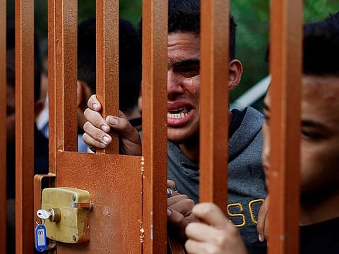 A mourner reacts as bodies of Palestinians killed in Israeli strikes lie at a hospital in Khan Younis in the southern Gaza Strip, October 17, 2023