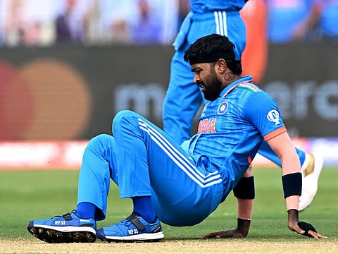 India's Hardik Pandya falls on the field during the 2023 ICC Men's Cricket World Cup ODI match against Bangladesh at the Maharashtra Cricket Association Stadium in Pune on October 19, 2023.