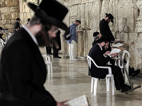 Ultra Orthodox Jewish devotees pray at the Western Wall, the holiest site where Jews are allowed to pray, in the Old City of Jerusalem on October 18, 2023.