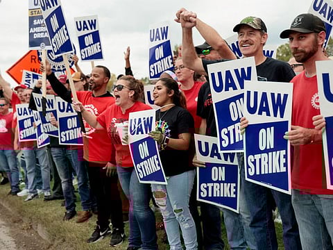 Striking United Auto Workers (UAW) members from the General Motors Lansing Delta Plant picket in Delta Township, Michigan.