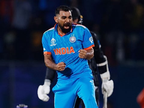 India's Mohammed Shami celebrates after taking the wicket of New Zealand's Matt Henry at Himachal Pradesh Cricket Association Stadium, Dharamsala, on Sunday.