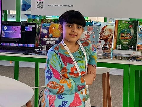 Nine-year-old AlDhabi Al Mheiri with her many book releases.