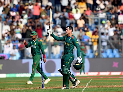 South Africa's Quinton de Kock raises his bat as he celebrates his century during their match against Bangladesh in the World Cup, at Wankhede Stadium, in Mumbai on Tuesday.