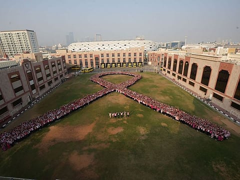 The huge single human bow formed by students of Indian High School.