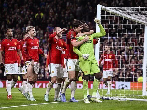 Manchester United's goalkeeper Andre Onana celebrates with teammates after saving a penalty kick at the end of the Champions League Group A match against FC Copenhagen at Old Trafford, in Manchester, north-west England, on Tuesday.
