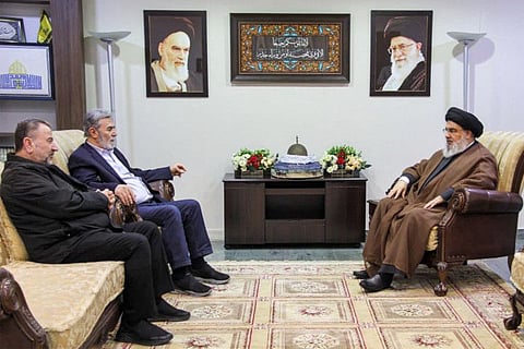 This handout picture provided by the media office of the Hezbollah Lebanese Shiite movement on October 25, 2023, shows the group's secretary-general Hassan Nasrallah (right) meeting with with the Palestinian secretary-general of the Islamic Jihad movement Ziad Nakhale (second left) and the Hamas movement's deputy chief of political affairs Saleh Al Arouri at an undisclosed location in Lebanon.