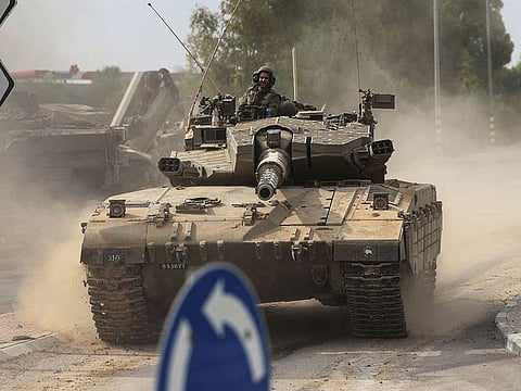 Israeli soldiers seen in a tank near Israel's border with Gaza