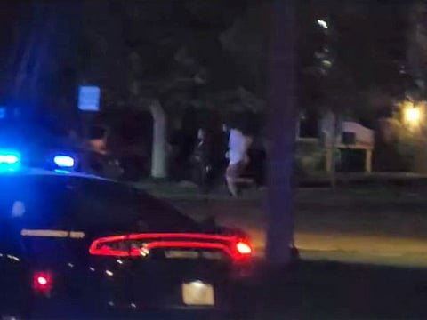 People run from the scene of a mass shooting in Lewiston, Maine.