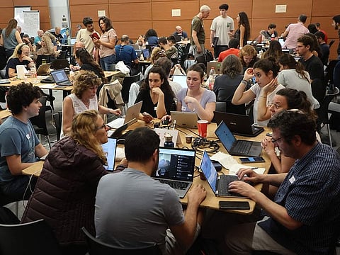 Volunteers take part in a taskforce in Tel Aviv to identify missing persons in the aftermath of a surprise attack by Hamas.