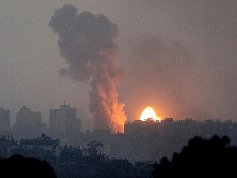 Fire and smoke rise following an Israeli airstrike in the Gaza Strip, as seen from southern Israel, on Saturday, October 28, 2023.