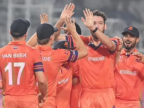 Netherlands' Paul van Meekeren (2nd right) celebrates with teammates after taking the wicket of Bangladesh's Mushfiqur Rahim during their 2023 ICC Men's Cricket World Cup match at the Eden Gardens in Kolkata on October 28, 2023.
