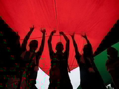 Protesters hold a giant Palestinian flag during a protest in support of Palestinians in Gaza