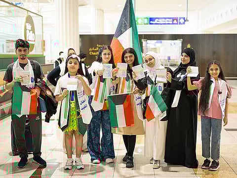 Arab Reading Challenge contestants showing special passport stamps commemorating the event, upon their arrival recently at Dubai International Airport
