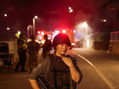 Israeli security forces and emergency services arrive as smoke rises from a house in the northern city of Kiryat Shmona after being reportedly hit by a rocket from Lebanon on October 29, 2023, amid increasing cross-border tensions.