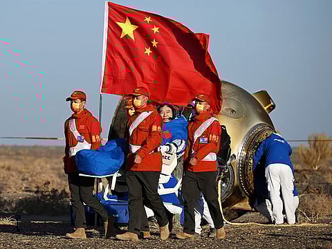 Astronaut Jing Haipeng waves as he is carried out of the re-entry capsule of the Shenzhou-14 manned space mission after it landed successfully at the Dongfeng landing site in northern China's Inner Mongolia Autonomous Region, on Tuesday, October 31, 2023.