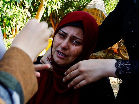 A mourner reacts near the bodies of Palestinians killed in Israeli strikes during their funeral, in Khan Younis in the southern Gaza Strip October 31, 2023.