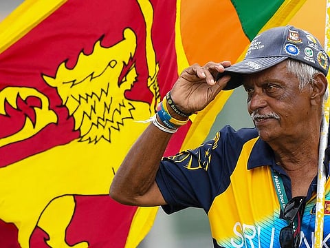 In this photograph taken on July 19, 2022, Sri Lanka's cricket fan Percy Abeysekera watches the fourth day play of the first cricket Test match between Sri Lanka and Pakistan at the Galle International Cricket Stadium in Galle.