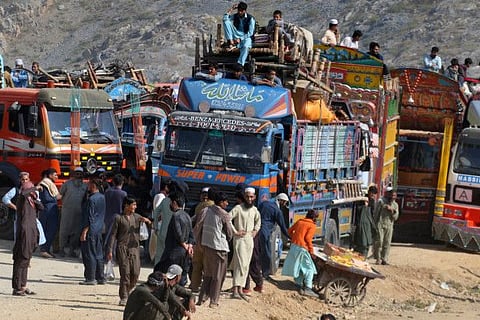 Afghan families onboard trucks wait for clearance to cross border through a border crossing point in Torkham, Pakistan, Tuesday, Oct. 31, 2023.